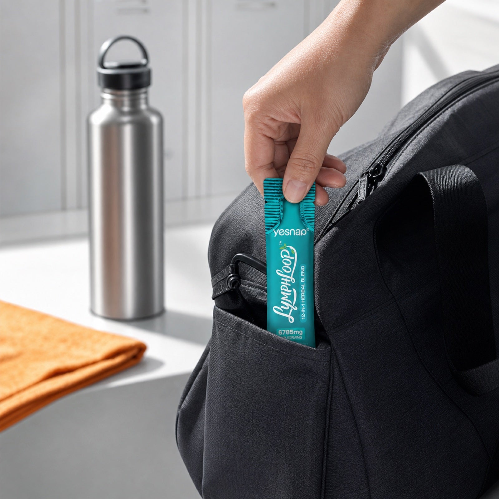 A Yesnap Lymphatic Support liquid stick slipped into an everyday bag